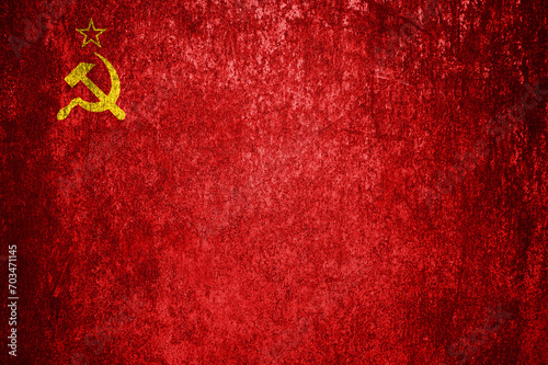 Close-up of the grunge flag of the Soviet Union. Dirty USSR flag on a metal surface. photo