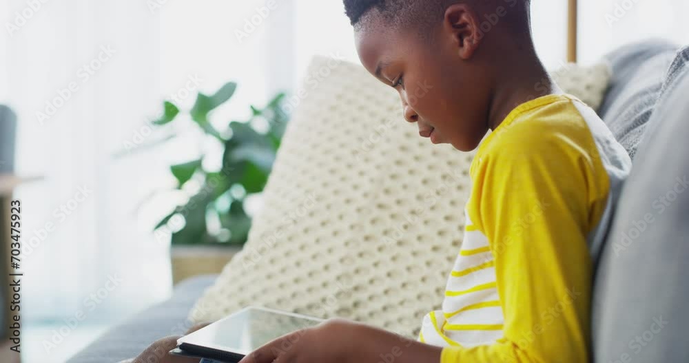 Child, boy and tablet, e learning or reading ebook with website for education gaming or video game. Young kid relax on couch, digital tech and connectivity, online course or gamer streaming at home