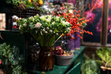 A variety of colors is near the flower shop. Large bouquets in tin vases.