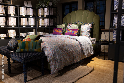 LONDON, UK - December 22, 2023: Interior in the Bedrooms department. Ornamental bed with Patchwork duvets, decorations in Liberty shopping mall, one of the oldest department stores in London. photo