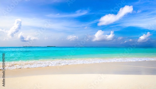 beautiful sandy beach with white sand and rolling calm wave of turquoise ocean on sunny day on background white clouds in blue sky island in maldives colorful perfect panoramic natural landscape
