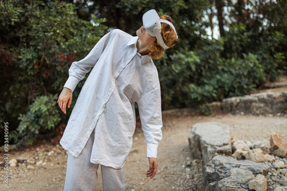 young woman happy success wearing virtual reality headset game entertainment in the forest. Winner of cyber future video game concept young woman happy success wearing virtual reality headset game entertainment in the forest. Winner of cyber future video game concept