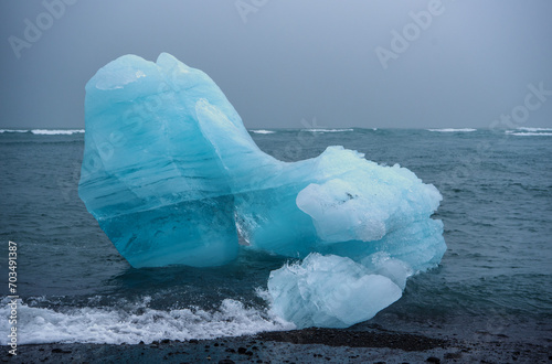 Blue Iceberg at the Black Breiðamerkursandur Beach in Southern Iceland