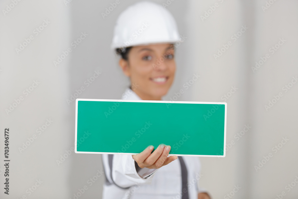 woman showing wet paint sign woman showing wet paint sign