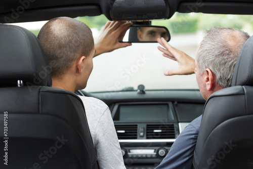 father and handsome son driving his car