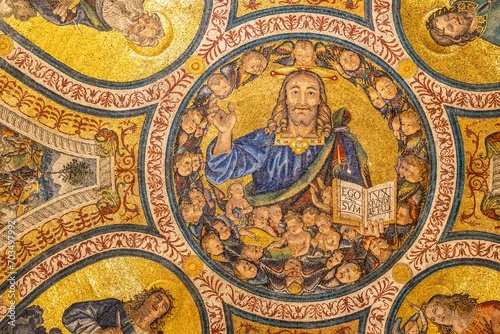 Close-up on colorful religious mosaic decorating interior of historic Basilica in Rome showing a smiley Jesus waving his hand