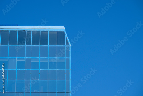 Blue sky reflection on a glass skyscrapper photo