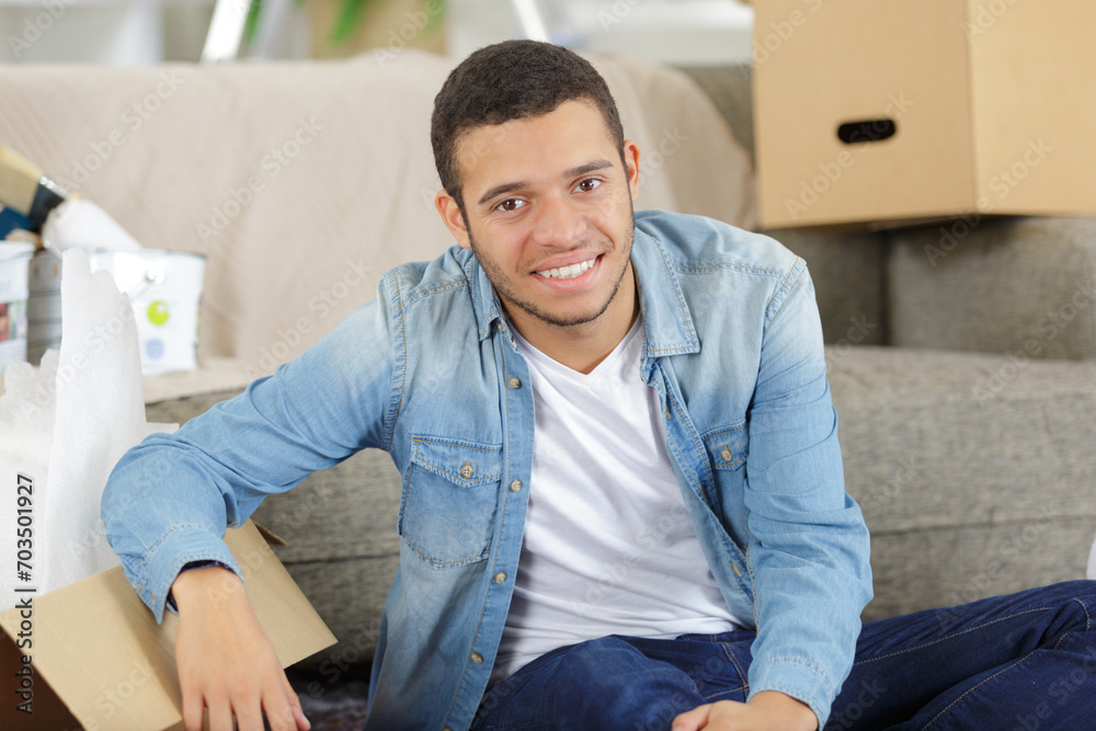 man with boxes and blueprint moving to new home man with boxes and blueprint moving to new home