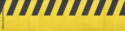 black and yellow danger or attention sign painted on concrete. Texture, template, pattern. Diagonal stripes. Seamless texture illustration