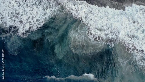 Play of waves on a black sand beach at Reunion Island