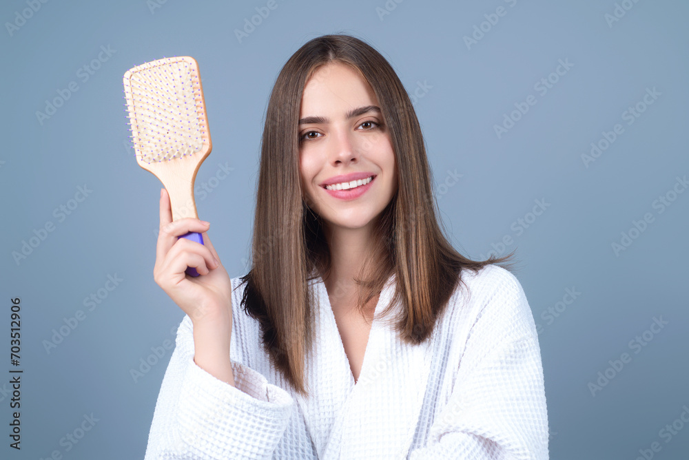 Girl combing hair with comb. Beautiful young woman holding hair comb. Female model hold comb near face. Woman portrait with comb. Girl combing hair with comb. Beautiful young woman holding hair comb. Female model hold comb near face. Woman portrait with comb.
