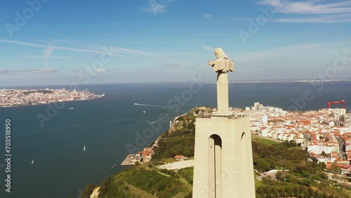 Captivating aerial panorama circles Cristo Rei statue, Tagus River, and Lisbon. A mesmerizing view of iconic landmarks and scenic beauty. photo