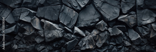 Black stone wall texture background, panoramic image of dark stone wall