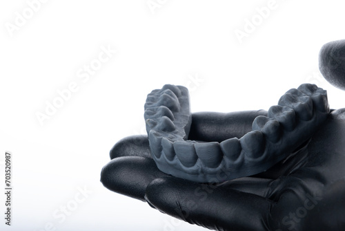 Dentist holding 3D impression mold isolated on white background.