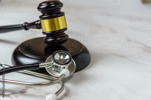 judge s gavel and a professional stethoscope representing legal decisions in health care. The intersection of law and medicine