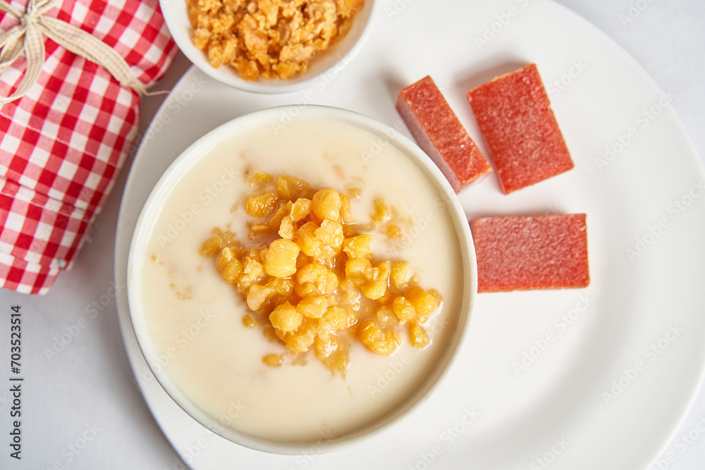 Vertical photo of Colombian traditional dish Mazamorra, accompanied by Bocadillo and crushed panela. Delicious Paisa cuisine Vertical photo of Colombian traditional dish Mazamorra, accompanied by Bocadillo and crushed panela. Delicious Paisa cuisine