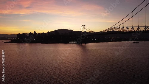 Sol nascendo em Florianópolis com vista para ponte Hercílio Luz photo