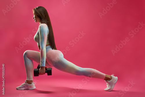 Εκτύπωση καμβά Athletic sexy woman in leggings stretching leg during fitness workout indoors