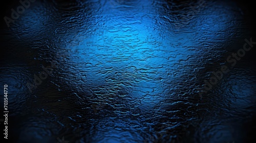 Mystical blue water surface. Detailed close-up of water ripples reflecting light in the dark