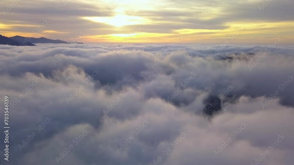 Fly above clouds in misty nature heaven landscape at golden sunrise Aerial view