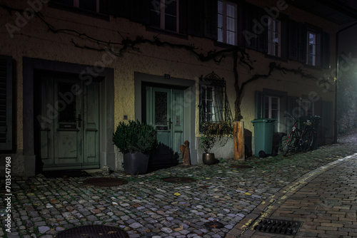 old house in the city of Rapperswil, picutre taken by night in the streetlight, shadows and light