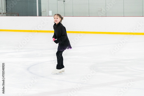 Figure skating practice at an indoor skating rink