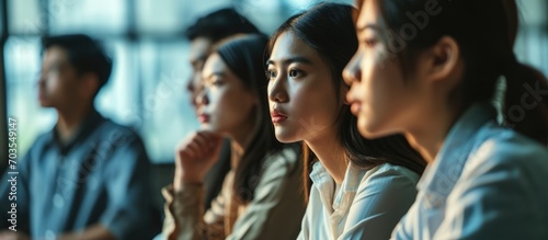 Job-seeking Asian youth participating in a group interview.