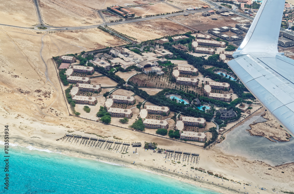 Aerial view from airplane of an tourist resort at the beach