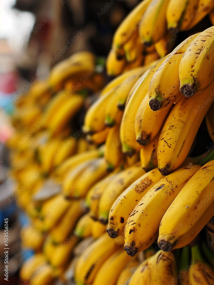 Ripe yellow bananas at the market.  Depth of field blur in background.