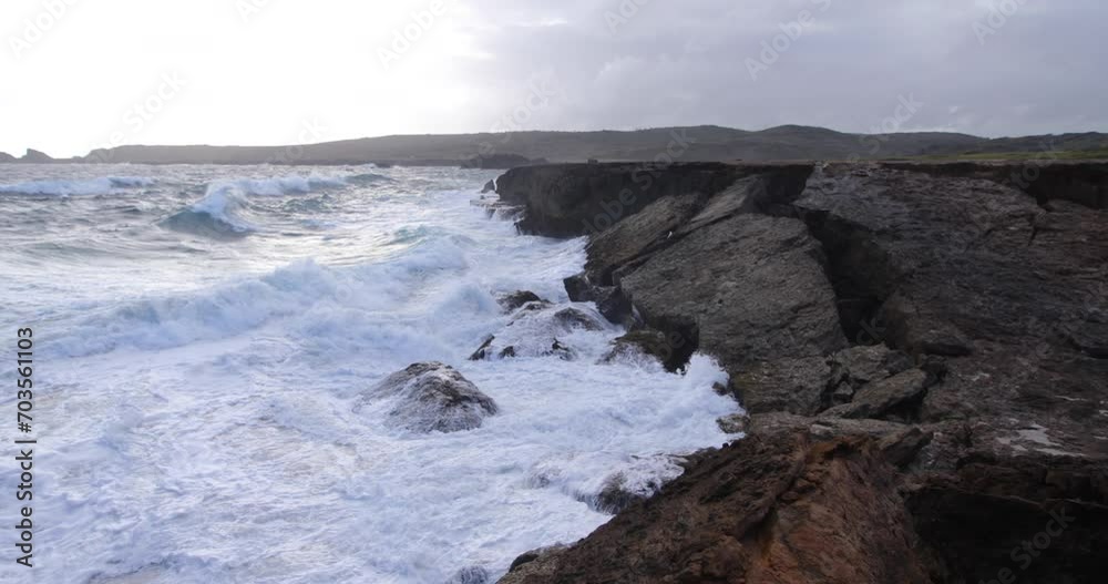 Foamy waves crashing on rocky Aruba shore - wide, steady cam shot Foamy waves crashing on rocky Aruba shore - wide, steady cam shot