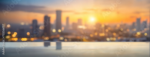 Sunset behind a blurred cityscape, with lights beginning to twinkle. The golden hour brings a soft glow to the urban skyline, reflecting off surfaces and signalling the transition from day to night.