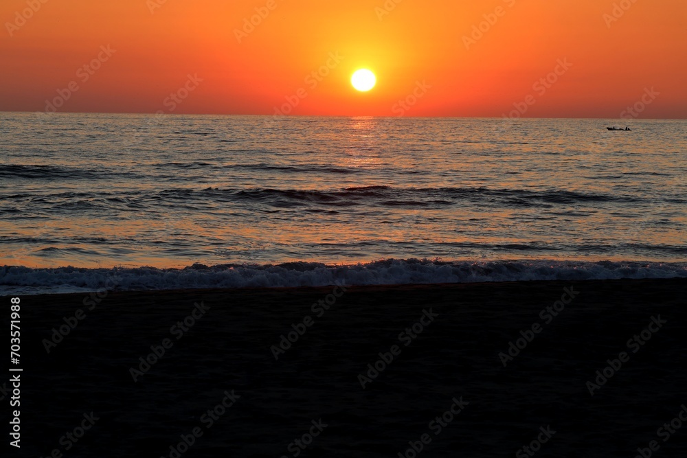 sunset at the ocean, the sun sinks into the sea sunset at the ocean, the sun sinks into the sea