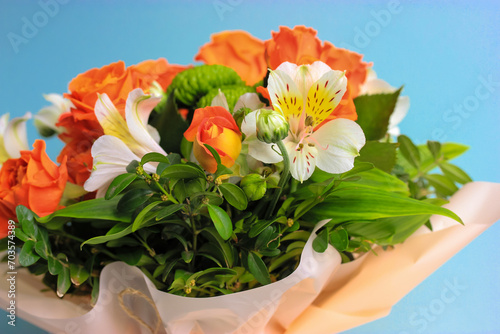 Beautiful bridal bouquet of different flowers alstromeria. Orange white yellow alstromerias bunch of fresh blossoming tropical flowers. Florist shop. photo