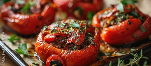 Stuffed red peppers with meat and herbs, baked on a sheet.
