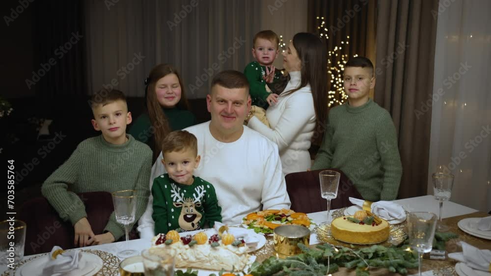 Concept Christmas table. Happy family with children sitting at the festive table. Concept Christmas table. Happy family with children sitting at the festive table.