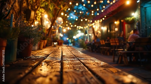 Beautiful background with street cafe empty tables at narrow street at night  bokeh  blurred lights 