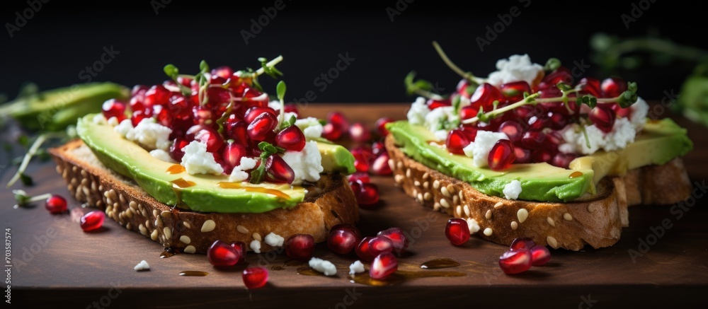 Feta and avocado sandwiches topped with pomegranate seeds.