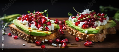 Feta and avocado sandwiches topped with pomegranate seeds.