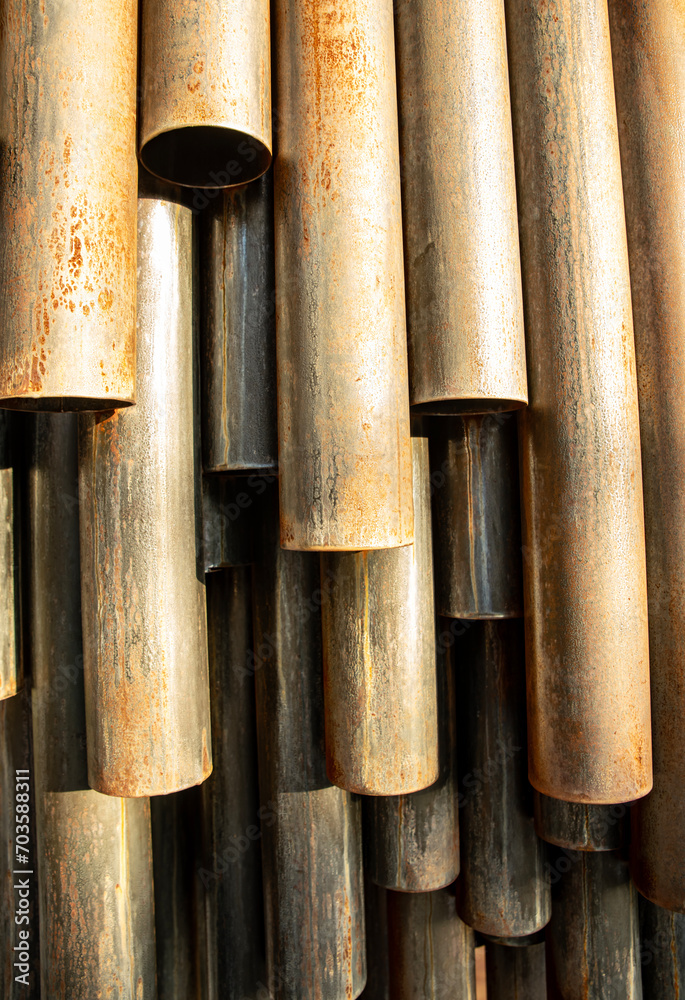 Rusty iron, Symmetrical metal pipes under the sun, with light shadow Rusty iron, Symmetrical metal pipes under the sun, with light shadow