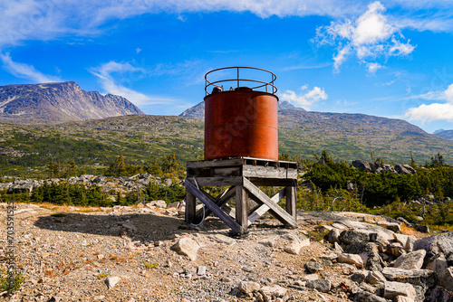 Weathered water tower in the wilderness - Rusty reservoir in the Chilkoot Trail National Historic Site, British Columbia, Canada photo