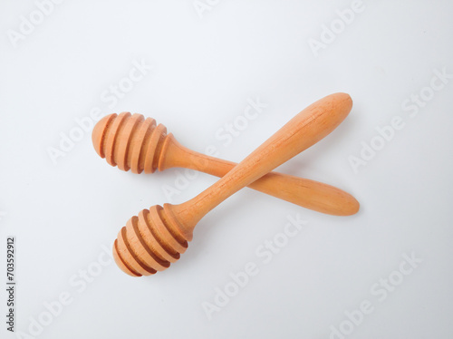 Wooden honey spoon isolated on white background