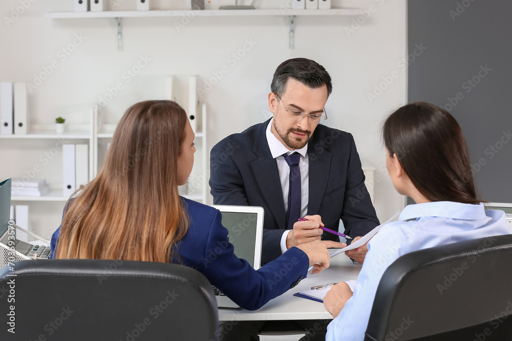 Human resources commission interviewing male applicant in office Human resources commission interviewing male applicant in office