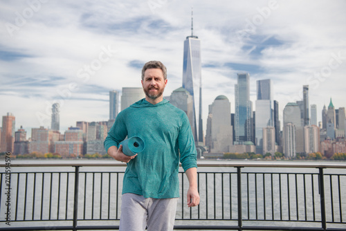 Man doing workout in NYC. Sports athlete doing workout practice for cardio wellness, physical fitness and training outdoor. Mature man workout senior man enjoying active lifestyle outside in New York.