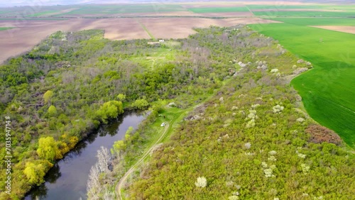 Wallpaper Mural Drone footage of dense woods and plain cultivated fields surrounding a lake Calma, Serbia Torontodigital.ca