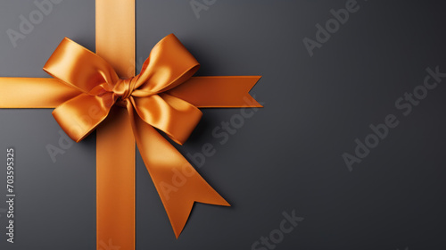 A vibrant Orange gift ribbon with a bow against a gray background