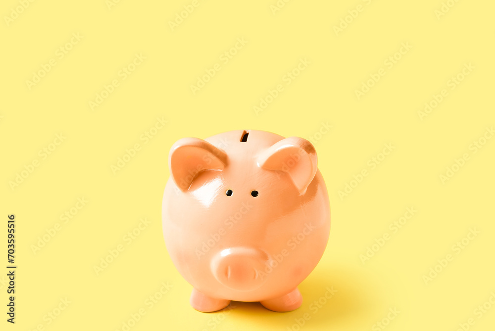 Piggy bank on yellow background Piggy bank on yellow background
