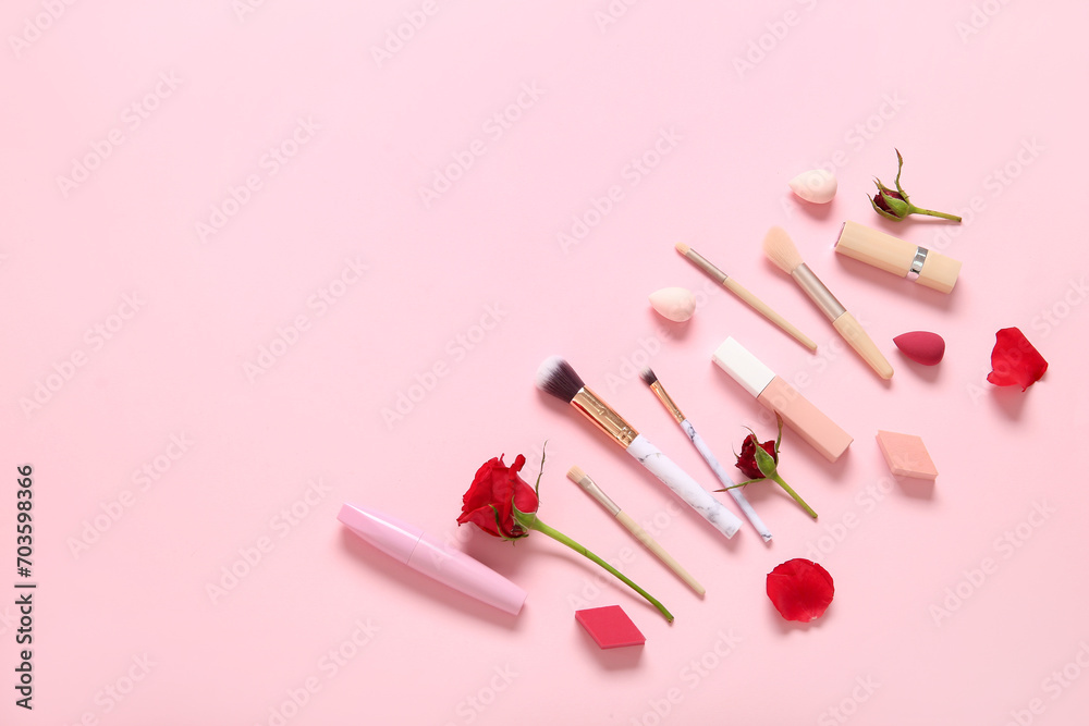 Composition with makeup products and beautiful red rose flowers on pink background Composition with makeup products and beautiful red rose flowers on pink background