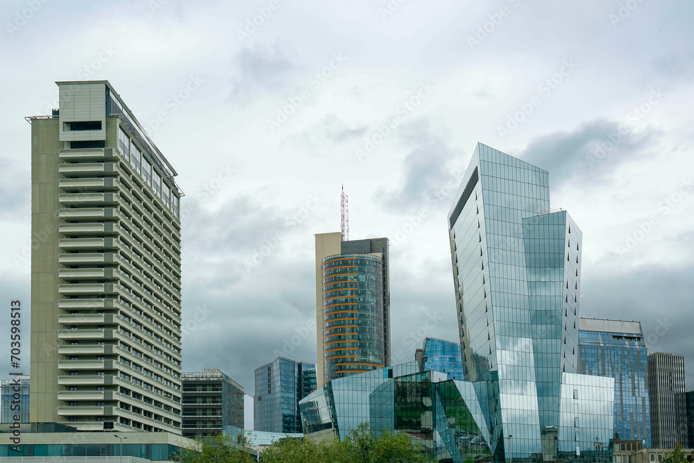 View of modern skyscrapers in city on cloudy day
