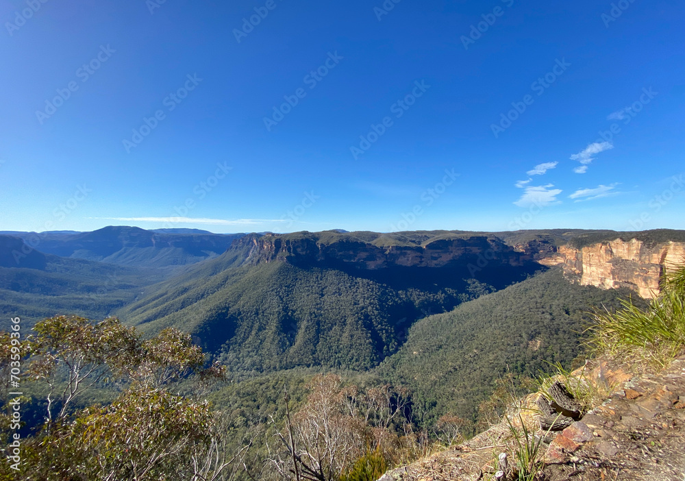 Spectacular views from a mountain-top lookout. Green mountains in the horizon. Blue mountains, Australia, NSW. Unusual rock formation. Summit of the mountain.