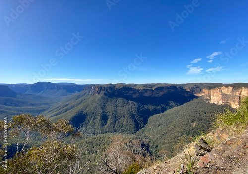 Spectacular views from a mountain-top lookout. Green mountains in the horizon. Blue mountains, Australia, NSW. Unusual rock formation. Summit of the mountain. © Stephanie